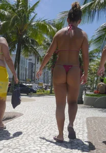 Big booty babe walking by the beach in thong