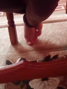 Crossed Female Feet Under Chair Closeup Creepshot