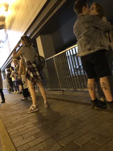 Cute Teen in Shorts on the Tram Stop