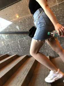 Hot chick wearing a fringed skirt walking up the stairs