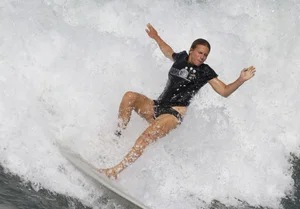 Candid surfer in falling off her board