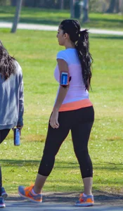 Thick lady walking in leggings with a big booty