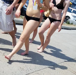 Cute brunette looking sexy in black bikini with friends