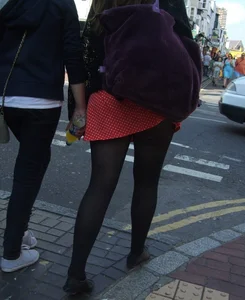 Girl in a pink skirt and stockings accidentally showing some cheek