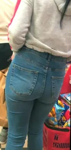 Skinny brunette with a nice booty in line in tight jeans