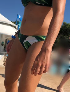 Blonde looking sexy in a green bikini at the pool
