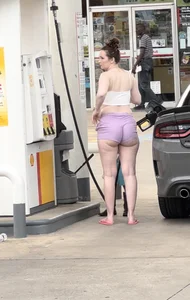 Milf with ass cheeks hanging out of her shorts at the gas station