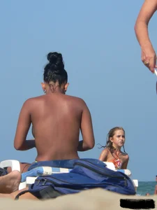 Hot ass topless beach girl with great tits lets her little brother oil up her ass in thong bikini