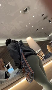 Sexy bubble butt in tight green leggings at the mall