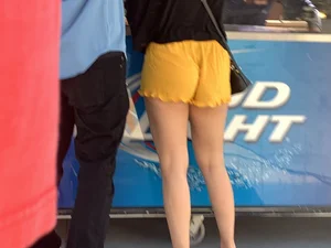Bunch of girls in various outfits at a Cardinals baseball game