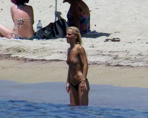 Small boobed topless milf on the beach