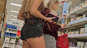 Booty peaking out of black denim shorts