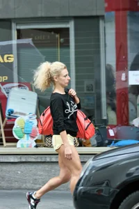 Blonde looking sexy walking in short yellow shorts