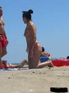 Purple thong topless lady on the beach gets oiled up by her husband