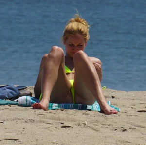 Sexy ass blonde milf on the beach in a thong with cameltoe and bending over