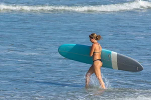 Candid girls surfing on the beach