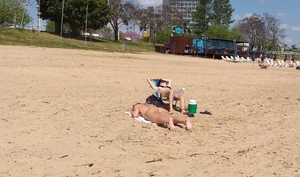 Girl laying out getting sun in a white thong bikini