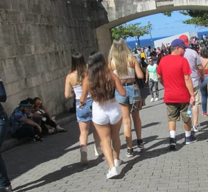 Three sexy friends in denim shorts and a skirt