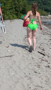 Beautiful Brown hair tight Girl in green bikini on the beach. oc