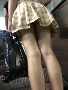 Cute Blonde Candid Girl in a Skirt Flashing Panties on a Subway Escalator Photos