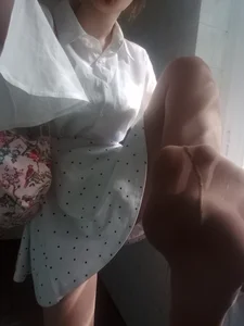 Teen in Polka-Dot Dress and Pantyhose Showing Her Feet on Camera Photos