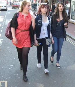 Girl in a pink skirt and stockings accidentally showing some cheek