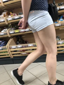 Girl with Muscular Legs in Mini Shorts Store Candid Closeup
