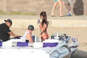 Brunette on a boat in red thong bikini with a tight little ass