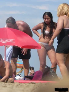 Couple of thick beach teens in little thong bikinis