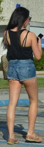 Brunette in short denim shorts showing a little cheek