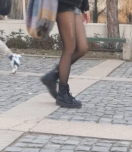 Sexy legs in ripped black pantyhose street closeups