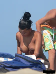 Hot ass topless beach girl with great tits lets her little brother oil up her ass in thong bikini