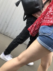 Very hot candid girl in denim shorts walking down the train platform