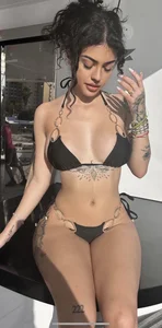 Hot tatooed non-candid girl in a swimsuit, slim waist and broad hips