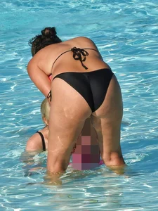 Sexy milf with a nice mom bod in a bikini in the pool