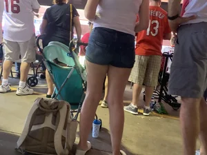 Bunch of girls in various outfits at a Cardinals baseball game