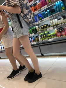 Girl in Blue Denim Shorts with Very Skinny Legs Store Candid