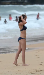 Hottie bikini babe on the beach kicking around a volleyball