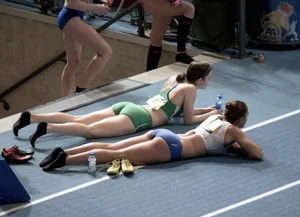 Female Athletes in Spandex Tops and Shorts Lying on the Floor
