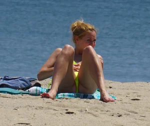 Sexy ass blonde milf on the beach in a thong with cameltoe and bending over