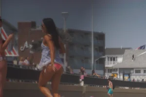 Trio of girls in bikinis on the beach and one with an incredible ass