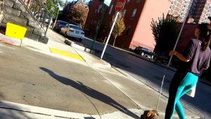 Sexy girl in teal spandex walking her dog