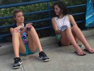 Hot Girls in Shorts Sitting on the Pavement With Spread Legs