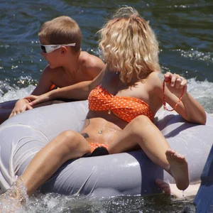 Sexy party girls in bikinis on a lake