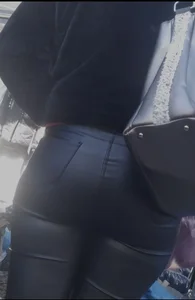 Milf shows off her shapely ass in her leather pants at the market