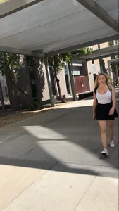 Gorgeous blonde college girl in a skirt passing by