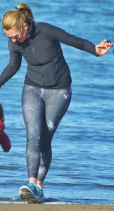 Beach redhead milf in patterened leggings at the beach