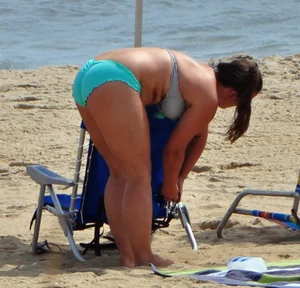 Thick beach girl in a teal bikini
