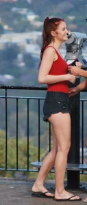 Redhead beauty in short shorts showing some cheeks and panties
