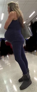 Pregnant blonde girl in leggings at the airport